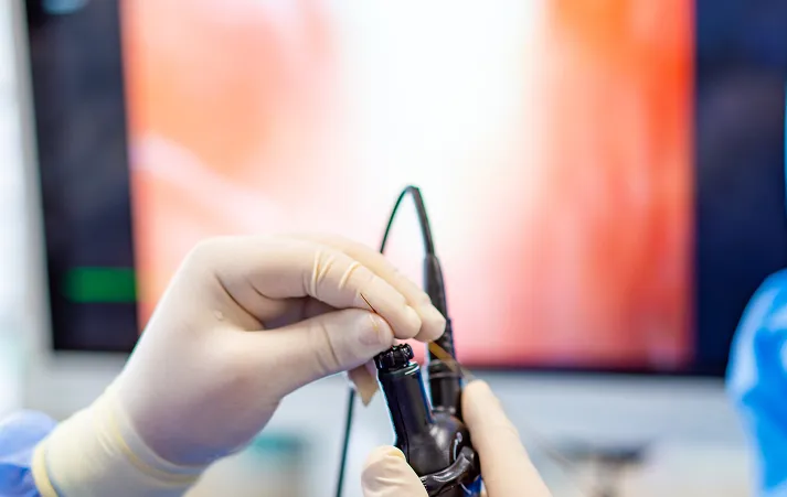 Surgeons performing a laparoscopic procedure using minimally invasive instruments.